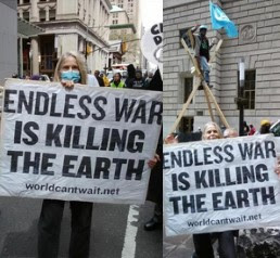 Carol Dudek marches down the middle of Broadway in lower Manhattan in a joint demonstration on Mon. March 18 of the anti-war movement with NYC Extinction Rebellion (XR). Then, she stands next to XR activists engaged in a non-violent direct action blocking traffic across from the famous Wall Street bull, calling for No Wars, No Warming.